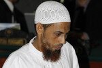 Umar Patek arrives in court February 13th. Patek, a militant Islamist captured in the same Pakistan town where US forces killed Osama bin Laden, is on trial on charges of making bombs that exploded at Bali nightclubs in 2002, killing 202 people. [Reuters]
