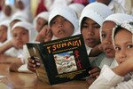 Acehnese elementary students listen to instructions during an Indonesian Red Cross tsunami training exercise on the outskirts of Banda Aceh. Indonesia has made significant strides in educating its residents about disaster threats, but analysts say more needs to be done to enhance preparedness. [Tarmizy Harva/Reuters]