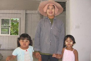 Phuket resident Khin Myowin, an ethnic Mon, with her daughter Karn (left) and a young cousin. Mons are easily identified by the swirls of beige powder they apply to their faces. As Burma's government takes some positive steps, including holding elections, towards re-establishing democracy, many Burmese migrant workers are considering a return to their homeland. [Samila Nararanod/Khabar]
