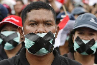 People cover their mouths as a sign of protest during a rally in Jakarta on August 15th, 2010, demanding the government do more to protect freedom of religion and to punish hardline groups which have attacked minority faiths. Shia Muslims are among the groups which have recently come under pressure in Indonesia despite its history of tolerance and pluralism. [Supri/Reuters]  