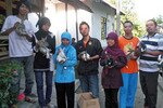 Essy Purwaningtyas (second from left) and other students from the State University of Yogyakarta display rabbits from the programme they helped start to empower disabled people in Karangpatihan village in Ponorogo, East Java. [Yenny Herawati/Khabar]
