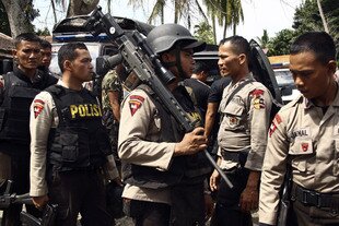 Indonesian police officers gather after a raid on an Islamic militant training camp in Aceh Besar on March 6th, 2010. Officials and experts say Aceh's new leadership must remain vigilant about the threat of terrorism in the province. [Stringer/Reuters]