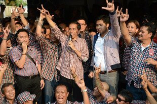 Governor Joko Widodo (centre, with microphone) gestures as he speaks at a press conference in Jakarta on September 20th, 2012. Polls show the 51-year-old governor beating out most other potential candidates for the 2014 presidential election, in what analysts say is another sign that Indonesian politics is changing. [Adek Berry/AFP].