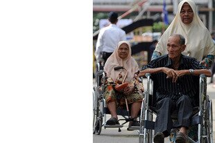 Disabled citizens arrive at a polling station in the northeastern state of Terengganu to cast their votes on January 17th, 2009. Malaysia is improving its efforts to provide access and services for disabled people, government officials say. [Saeed Khan/AFP].