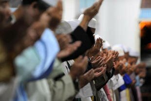 Muslims pray in Pontian, Malaysia, hometown of terrorist mastermind Noordin M. Top. Malaysia cannot be complacent about terrorism, concerned citizens say. A key way to fight terrorism is educating people about correct teachings of Islam. [Saeed Khan/AFP]