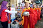 Seorang karyawan toko Muslim memberikan sedekah kepada para biksu Budha di Magelang, Jawa Tengah. Pada bulan Mei, kelompok minoritas Budha di Indonesia merayakan Waisak, sebuah festival keagamaan yang memperingati kelahiran, pencerahan, dan wafatnya Sang Budha. Para pemimpin agama mengambil kesempatan ini untuk mendorong toleransi beragama. [AFP/Clara Prima]