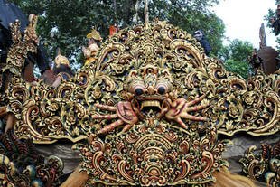 Dancers ride aboard an ornately carved float during June 15th's opening parade. [Sonny Tumbleka/AFP]
