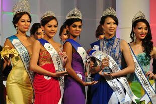 Miss Malaysia Tourism 2013 Thaarah Ganesan (in purple) poses with 2nd runner up Jennifer Ling (in red) and 1st runner up Renee Tan Joe May (in blue) at the pageant finale in Kuala Lumpur on July 7th. Due to a fatwa banning Muslim participation, few ethnic Malays compete in such contests. In late July, four Muslim finalists were disqualified from Miss Malaysia World 2013. [Grace Chen/Khabar]