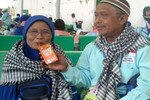 Jemaah haji Sukariyani dan suaminya Muhammad Dariyanto tiba di Bandara Internasional Adisumarmo pada tanggal 20 Oktober. Lebih dari 4.100 umat Muslim Indonesia kembali dari ibadah haji mereka hari itu. [Aditya Surya/Khabar]