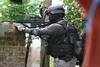 A member of Densus 88 takes aim at a house in Bandung where suspects traded fire with police on May 8th, 2013. The counterterrorism unit faces criticism for alleged excessive use of force in its operations. [Usep Usman Nasrullah/AFP]