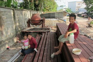 Burmese ethnic Mon boy Ong (right), is shown in late January with his aunt Auey and his young cousin at a migrant workers' camp near Phuket town. [Somchai Huasaikul/Khabar]