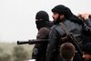 Para pejuang jihad Al-Nusra Front berdiri di atas sebuah truk bak terbuka yang dipasangi senapan mesin selama pertempuran di Aziza, Suriah, pada tanggal 4 April 2013. Lebih dari 55 jihadis Indonesia tewas dalam perang sipil Suriah antara tahun 2011 dan pertengahan 2013, menurut seorang pakar. [Guillaume Briquet/AFP]
