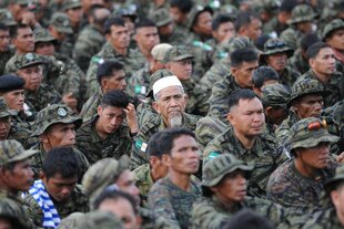 Moro Islamic Liberation Front (MILF) rebels attend a March 27th Sultan Kudarat, Philippines rally in favour of a peace agreement with the Filipino government. [Ted Aljibe/AFP] 