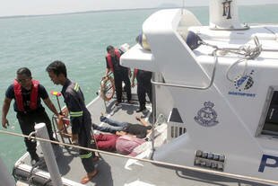 Marine police officers retrieve bodies of victims Wednesday (June 18th) after a boat of illegal migrants capsized overnight off western Malaysia. [AFP/Malaysia Maritime Enforcement]