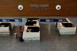 A passenger waits May 2nd at the immigration counter in the new terminal at Kuala Lumpur International Airport (KLIA2). Iranians entering Malaysia can no longer obtain visas upon arrival. [Manan Vatsyayana/AFP]