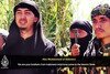  A man identifying himself as Abu Muhammad al-Indonesi (the Indonesian), left, appearsin an ISIL propaganda video published July 23rd on YouTube. His words, spoken in Bahasa, scroll as English subtitles at the bottom of the frame. [YouTube] 