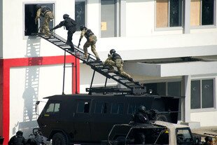  Anti-terrorist troops take part in a September 2013 exercise at the Indonesia Peace and Security Centre in Sentul, West Java. As part of its operations, the centre now houses convicted terrorists being de-radicalised. [Bay Ismoyo/AFP] 