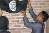  Densus 88 personnel take down an ISIS flag in Gendingan Village, East Java on August 8th. [Eko Prasety/Khabar] 
