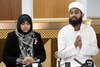  Imam Asim Hussain (right) and doctor Shameela Islam-Zulfiqar, who travelled with British aid worker Alan Henning on humanitarian missions to Syria, appear at a press conference in Manchester, England on October 4th to discuss his apparent murder by the Islamic State of Iraq and Syria (ISIS). [Oli Scarff/AFP] 