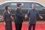 Indian Prime Minister Manmohan Singh (right) escorts Japanese Prime Minister Yoshihiko Noda (center) and his wife Hitomi during their ceremonial reception at the presidential palace in New Delhi, December 28th. During their annual meeting, leaders reached agreements covering business, economic ties and security concerns. (Reuters)