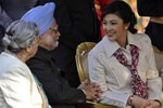 Thai Prime Minister Yingluck Shinawatra (right) speaks with her Indian counterpart Manmohan Singh as his wife Gursharan Kaur (left) looks on during a reception at Rashtrapati Bhaban (presidential palace) after the Republic Day parade in New Delhi on January 26th, 2012. Singh and Yingluck finalised a free-trade agreement during the visit. [Reuters]