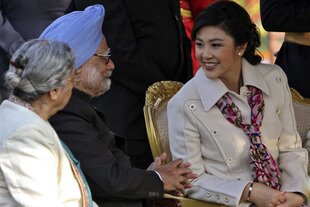 Thai Prime Minister Yingluck Shinawatra (right) speaks with her Indian counterpart Manmohan Singh as his wife Gursharan Kaur (left) looks on during a reception at Rashtrapati Bhaban (presidential palace) after the Republic Day parade in New Delhi on January 26th, 2012. Singh and Yingluck finalised a free-trade agreement during the visit. [Reuters]