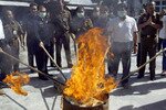 Indonesian officials burn heroin seized in a 2005 case in which nine Australians were convicted of trying to smuggle 6.1kg (13lbs) of heroin to Australia from Bali, and given sentences ranging from life in prison to death. Despite such consequences, drug smuggling, production, and abuse are on the rise. [Reuters]