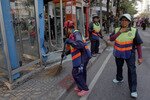 Cleaners sweep around phone booths in Bangkok Tuesday (February 14th) as police and forensic experts investigate the site where a bomb carried by Iranian national Saied Moradi exploded, seriously wounding him. [Reuters]