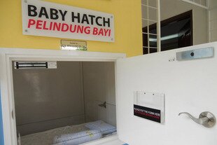 The Baby Hatch in Petaling Jaya, outside Kuala Lumpur, is a place where individuals can anonymously leave an unwanted baby. A sensor under the mattress immediately alerts an on-site caretaker to retrieve the baby; the closing of the door triggers lights and ventilation inside the hatch. After a week, babies are turned over to the State Welfare Organisation to start the adoption process. [Hana Kamaruddin/Khabar]