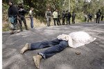 The dead body of a Muslim villager slain by insurgents lies on the ground after a 2011 attack in Pattani province. The Organisation of Islamic Co-operation completed a fact-finding mission to Thailand's Deep South on Sunday, rejecting separatism and calling for a peaceful solution. [Surapan Boonthanom/Reuters]