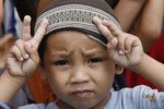 A Muslim boy participates in a demonstration calling for an end to violence in the Philippines. A poverty alleviation programme in the country seeks to empower local communities, placing decision-making responsibility in the hands of local residents. [Romeo Ranoco/Reuters] 