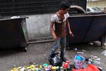 An addict in Chow Kit sifts through rubbish to look for recyclables to sell to support his habit. The low-income district of Kuala Lumpur, known for sex work, drug sales and crime, is far cleaner and safer than it was 40 years ago. [Grace Chen/Khabar]