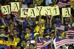 Malaysian fans hold placards during their 2014 FIFA World Cup qualification football match against Singapore in Kuala Lumpur July 28th, 2011. Illegal football betting is a serious problem in Malaysia. In raids conducted in July, police uncovered bets worth some 49 million ringgit ($15.7 million) on European Football Cup matches. [Bazuki Muhammad/Reuters]