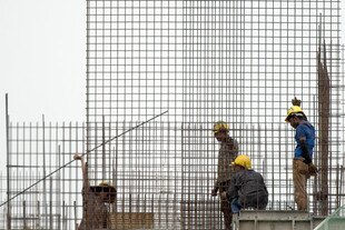 Labourers work at a construction site in Kuala Lumpur, November 30th. The Bureau of Manpower, Employment and Training (BMET) announced Sunday (December 2nd) it would begin processing registrations of Bangladeshi workers seeking jobs in Malaysia at the end of December. [Saeed Khan/AFP] 
