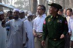 Indonesian Foreign Minister Marty Natalegawa, centre, and Burmese Border Affairs Minister Lt. General Thein Htay, right, walk with local residents during a visit to Burma's Rakhine state. [AFP/Indonesian Embassy handout]