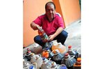 Yusri Ahmad collects used cooking oil from the residents of Desa Pantai Rakyat Condominium in Kuala Lumpur in order to convert it into bio-diesel. [Grace Chen/Khabar]