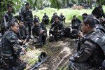 Malaysian soldiers prepare March 14th for more operations to rout Filipino gunmen in the area of Sungai Nyamuk, in Sabah state. Over 60 people have died since early February, when armed followers of a would-be sultan landed in Malaysian territory. [AFP/Malaysia Ministry of Defence].