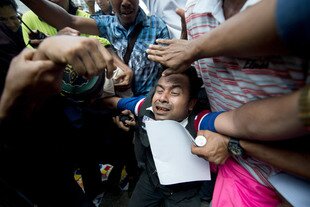 A Burmese ethnic Rohingya man (centre) collapses during a protest in Kuala Lumpur on Monday (March 25th) against the deadly religious riots between Buddhists and Muslims in Meiktila, central Burma. [Mohd Rasfan/AFP] 