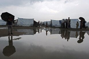 Muslim Rohingya stand near a puddle following heavy monsoon rains at the Say Thamagyi Internally Displaced Persons camp near Sittwe in Burma's western Rakhine state in October. The UN warned Friday (March 29th) the Rohingya Muslims again face 