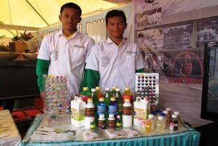 Rudi Muhammad Setiawan and Muhammad Alimal Yusri, chemistry students at the SMK Negeri 3 Medan, pose with their school products during National Information Week 2013 in Medan. The school advertises its products online. 