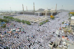 Muslim pilgrims perform the noon prayer outside the Namera Mosque in the plain of Arafat on the outskirts of Mecca in October 2012, as part of the annual Hajj. [Fayez Nureldine/AFP].