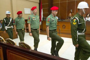 Members of Indonesia's Special Forces (Kopassus), Second Sergeant Ucok Tigor Simbolon (second from right), Second Sergeant Sugeng Sumaryanto (third from right) and First Corporal Kodik (second from left) arrive at their trial June 30th at a Bantu courtroom. On Thursday (August 1st), military prosecutors recommended eight to 12-year prison sentences for the eight Kopassus members accused of storming a jail and shooting and killing four inmates to avenge the death of a superior officer. [Suryo Wibowo/AFP]