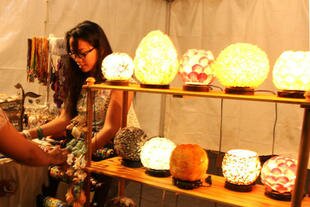 A woman browses among accessories and lamps made from seashells at a booth at Monas Fair. Business owner Cici Sri Sulastri, 30, started the small-scale enterprise while at university. She said the fair helped introduce her products to more people. [Zahara Tiba/Khabar]