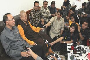 Religious Affairs Minister Suryadharma Ali (left) and Ekayana Buddhist Centre head Aryamaitri Mahasthawira speak to reporters at the centre a day after the attack. 