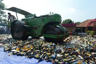 A steam roller destroys bottles of alcohol at a Jakarta police station on July 8th. The booze was seized during raids in the Indonesian capital as authorities prepared for Ramadan. Thanks to a recent Supreme Court ruling, local governments are now free to ban alcohol sales in their territory. [Adek Berry/AFP]