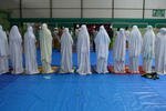 Shia Muslims pray in a temporary shelter in Sampang, Madura on November 30th, 2012, after being forced to flee their villages. On September 23rd, Sunni and Shia Muslims involved in the Sampang conflict agreed to reconcile, opening the way for the Shia to return home. [Adek Berry/AFP]