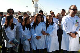Foreign medical personnel attend the funeral Monday (December 9th) of victims of the December 5th attack on the Yemeni defence ministry in Sanaa. The Philippines on Monday banned its citizens from taking new jobs in Yemen. [Mohammed Huwaisafp/AFP] 
