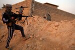 Anti-government fighters aim weapons as they hold a position in Fallujah, Iraq on January 21st. Indonesian Wildan Mukhollad bin Lasmin, a 19-year-old jihadist, reportedly was killed in Iraq in early February. [AFP] 