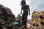 A 12-year-old boy scavenges at a dump in Medan. Ending poverty in Indonesia is essential to eradicating extremism, some observers say. [Sutanta Aditya/AFP]