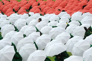 Nahdlatul Ulama supporters use umbrellas to form the red and white Indonesian flag during NU's 85th anniversary celebration in Jakarta in July 2011. The organisation is staying politically neutral during the 2014 presidential election. [Adek Berry/AFP]